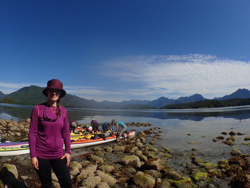 The Outdoor Girl on a beach in front of kayaks in the Broken Group Islands